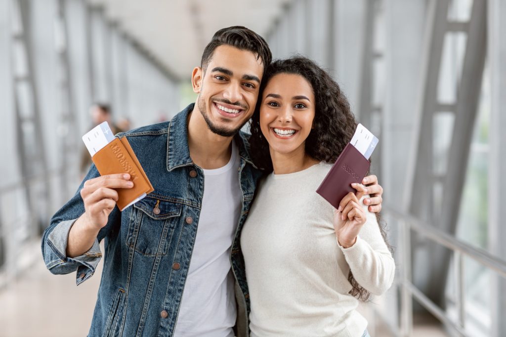 A couple showing their passports and Tickets